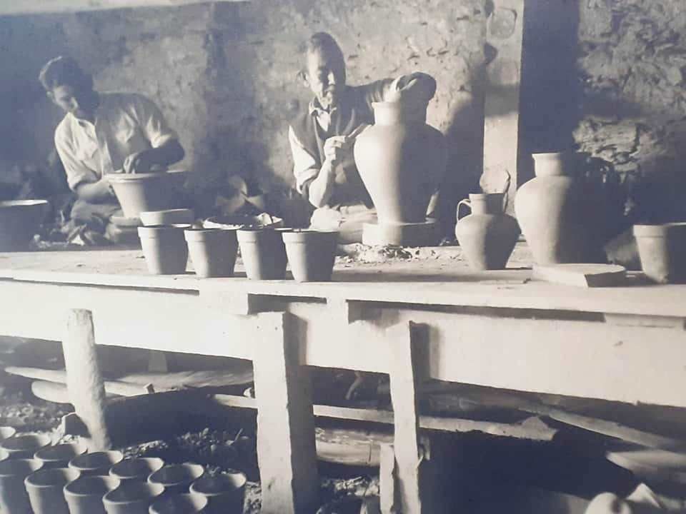 Potter working the clay on the wheel, archive photograph